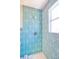 Beautiful bathroom with a walk-in shower, lovely tiling, and bright natural light from the window at 747 39Th Ne Ave, St Petersburg, FL 33703