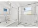 Clean and bright all-white bathroom with glass shower doors and modern fixtures at 747 39Th Ne Ave, St Petersburg, FL 33703