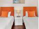 Cozy bedroom features two twin beds with vibrant orange accents and a 'DREAM' decor piece at 747 39Th Ne Ave, St Petersburg, FL 33703
