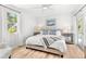 Bright and airy bedroom with light wood floors, a ceiling fan, and a lovely view from the window at 747 39Th Ne Ave, St Petersburg, FL 33703