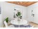 Inviting dining area with a white table, four chairs, and a decorative plant, complemented by a wood plank ceiling at 747 39Th Ne Ave, St Petersburg, FL 33703