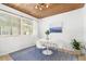 Bright dining room features wood plank ceiling, a round table with four chairs, large windows and a blue patterned rug at 747 39Th Ne Ave, St Petersburg, FL 33703