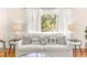 Bright living room with modern decor, comfortable white sofa, and views of the landscaped yard at 747 39Th Ne Ave, St Petersburg, FL 33703