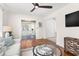 Bright living room featuring hardwood floors, white sofa, a glass coffee table, view of dining room, and large windows at 747 39Th Ne Ave, St Petersburg, FL 33703