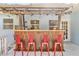 An outdoor bar with red barstools is ready for entertaining on the back porch at 747 39Th Ne Ave, St Petersburg, FL 33703