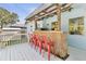 Outdoor bar features bamboo facade, weathered wood top, and a rustic pergola at 747 39Th Ne Ave, St Petersburg, FL 33703