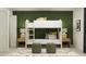 Charming bedroom with bunk beds, woven ottomans, and a green accent wall at 8108 Painted Sky Pl, Land O Lakes, FL 34637