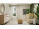 Cozy Bedroom featuring a wooden crib with stylish decor, dresser, and a sunlit window perfect for newborns at 8108 Painted Sky Pl, Land O Lakes, FL 34637