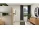 Modern bedroom with bunk beds, a window, woven ottomans, and a dresser with a cactus at 8108 Painted Sky Pl, Land O Lakes, FL 34637