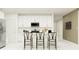 Kitchen features a modern design, stainless appliances, white cabinetry, and island seating at 8108 Painted Sky Pl, Land O Lakes, FL 34637