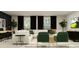 Stylish living room featuring a white sofa, green chairs, and modern decor at 8108 Painted Sky Pl, Land O Lakes, FL 34637