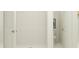 Modern shower with white tiling and a view into the adjacent bathroom area at 8108 Painted Sky Pl, Land O Lakes, FL 34637