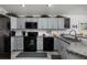 Well-appointed kitchen featuring granite counters, black appliances, ample cabinets, and modern fixtures at 9409 Sun Isle Ne Dr, St Petersburg, FL 33702