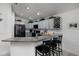Modern kitchen boasts granite countertops, stainless steel appliances, and stylish bar seating at 9409 Sun Isle Ne Dr, St Petersburg, FL 33702