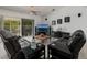 Comfortable living room featuring reclining sofas, modern decor, and access to the outdoor lanai at 9409 Sun Isle Ne Dr, St Petersburg, FL 33702