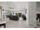 Open-concept living room with tiled floors, ceiling fans, and sliding glass doors to the lanai at 9409 Sun Isle Ne Dr, St Petersburg, FL 33702