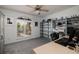 Bright office space featuring a large window, shelving, and neutral carpeting at 9409 Sun Isle Ne Dr, St Petersburg, FL 33702