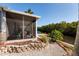 Tranquil outdoor patio with a waterfront view, tropical foliage, and access to the canal at 9409 Sun Isle Ne Dr, St Petersburg, FL 33702