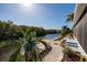 Scenic waterfront view showcasing a charming dock, lush greenery, and convenient canal access at 9409 Sun Isle Ne Dr, St Petersburg, FL 33702