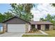 Charming home exterior featuring a stone facade, a well-manicured lawn, and a two-car garage at 959 Benninger Dr, Brandon, FL 33510