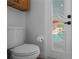 A toilet with a pool view beyond a partially louvered door at 9905 Woodbay Dr, Tampa, FL 33626