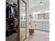 Luxurious primary bathroom featuring dual sinks, granite counters, and walk-in closet at 9905 Woodbay Dr, Tampa, FL 33626