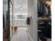 Hallway view of a luxurious bathroom and walk-in closet with custom shelving at 9905 Woodbay Dr, Tampa, FL 33626
