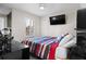 Standard bedroom with TV and a full-size bed. Plenty of natural light provided by the window with shutters at 9905 Woodbay Dr, Tampa, FL 33626