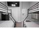 Shared bedroom with two sets of bunk beds and view into a brightly lit kitchen at 9905 Woodbay Dr, Tampa, FL 33626