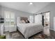 Well-lit bedroom with a king bed, bedside tables and direct access to a well appointed bathroom at 9905 Woodbay Dr, Tampa, FL 33626