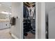 Walk-in closet with shelving and organizational space, next to a bathroom at 9905 Woodbay Dr, Tampa, FL 33626