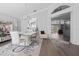 Elegant dining area with modern furnishings, stylish mirror, and view of the open floor plan at 9905 Woodbay Dr, Tampa, FL 33626