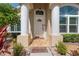 Inviting front entrance with decorative columns, stone walkway, and lush landscaping at 9905 Woodbay Dr, Tampa, FL 33626