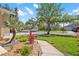 Well-manicured front yard with lush landscaping, vibrant plants, and a welcoming walkway leading to the home at 9905 Woodbay Dr, Tampa, FL 33626