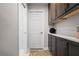 Hallway with cabinets, a sleek countertop, and a decorative rug, offering storage and style at 9905 Woodbay Dr, Tampa, FL 33626