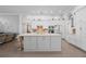 Spacious kitchen featuring a large island, white cabinets, modern appliances, and stylish pendant lighting at 9905 Woodbay Dr, Tampa, FL 33626