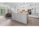 Modern kitchen with stainless appliances, custom cabinets, and a central island overlooking the living area at 9905 Woodbay Dr, Tampa, FL 33626