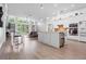 Open-concept kitchen featuring stainless steel appliances, white cabinetry, and a spacious island at 9905 Woodbay Dr, Tampa, FL 33626