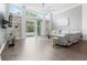 Bright living room featuring built-in shelves and sliding glass doors to backyard at 9905 Woodbay Dr, Tampa, FL 33626