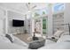 Bright living room with high ceilings, built-in shelving and sliding glass doors to backyard at 9905 Woodbay Dr, Tampa, FL 33626
