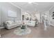 Open-concept living room with hardwood floors connecting kitchen and dining area at 9905 Woodbay Dr, Tampa, FL 33626