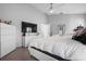 Bright main bedroom featuring hardwood floors, natural light, and a contemporary dresser at 9905 Woodbay Dr, Tampa, FL 33626