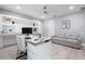 Bright office offers built-in shelving, a contemporary desk, a comfortable sofa, and natural light at 9905 Woodbay Dr, Tampa, FL 33626