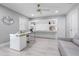 Office features a modern desk, shelving, and a ceiling fan, creating a workspace bathed in natural light at 9905 Woodbay Dr, Tampa, FL 33626