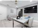 Modern office with a white desk, sofa, sliding door, and mounted TV, creating a productive space at 9905 Woodbay Dr, Tampa, FL 33626
