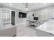Office with a modern desk, sofa, sliding barn door, and natural lighting at 9905 Woodbay Dr, Tampa, FL 33626