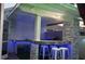 Outdoor kitchen with bar seating and blue accent lights perfect for entertaining at 9905 Woodbay Dr, Tampa, FL 33626