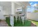 Outdoor kitchen with stainless steel appliances, a built-in grill, and bar seating at 9905 Woodbay Dr, Tampa, FL 33626