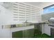 This outdoor kitchen features stainless steel cabinets, a sink, and a built-in grill for outdoor entertaining at 9905 Woodbay Dr, Tampa, FL 33626