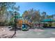 Community playground with multiple slides, climbing structures, and shaded seating areas at 9905 Woodbay Dr, Tampa, FL 33626